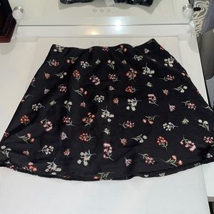 Floral over black skirt.